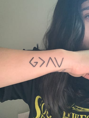 Customer photo review of God is greater Tattoo