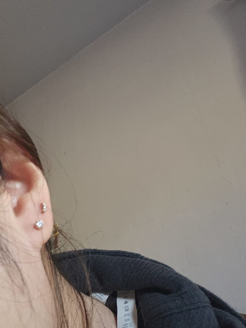 Customer photo review of 14K Gold Moissanite 6 Pronged Internally Threaded Labret Piercing 18G16G