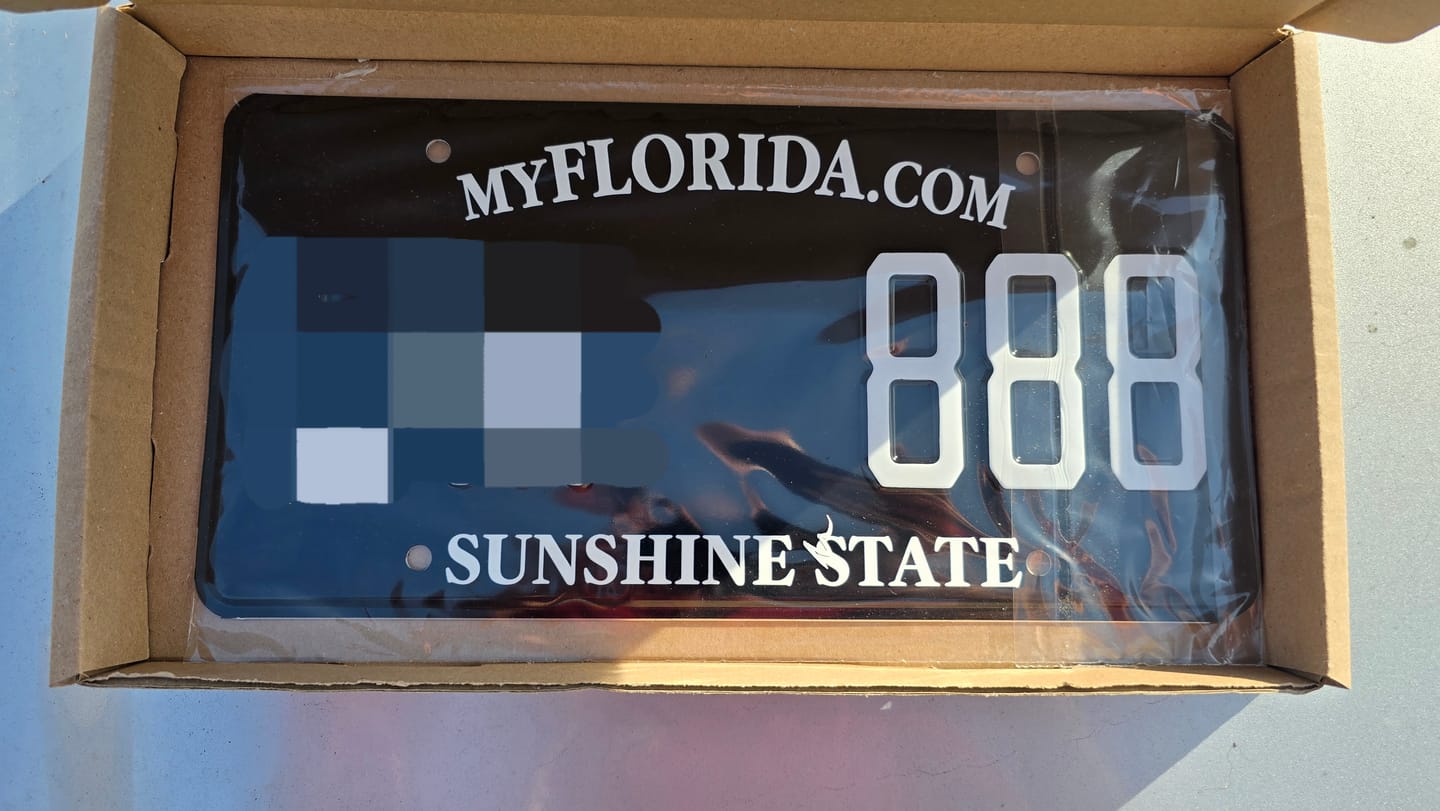 Customer photo review of BLACK FLORIDA LICENSE PLATE WITH WHITE TEXT - SUNSHINE STATE 12x6