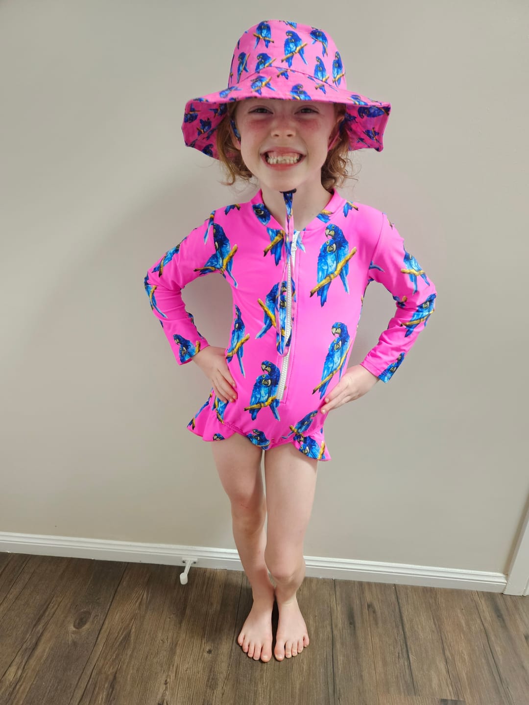 Customer photo review of Fluro Macaw Girls Long Sleeve Zip Swimmers