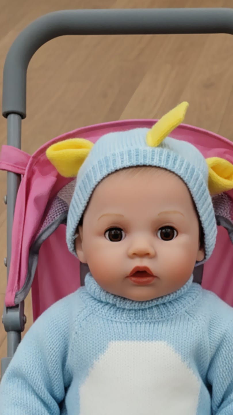Customer photo review of Interactive Baby Doll – Moves Face While Feeding
