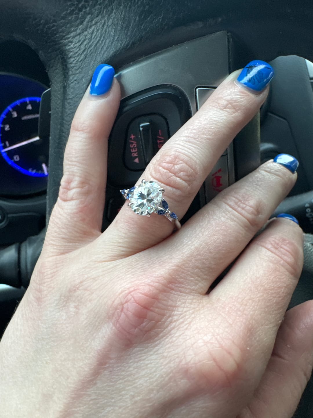 Customer photo review of Oval Cut Moissanite With Marquise Sapphire Petals Accents Engagement Ring
