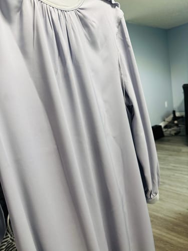 Customer's close-up of the Lina Satin Flare Dress in Ocean Mist, showing the gathered neckline and smooth satin fabric.