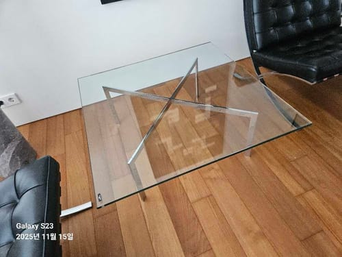 Customer photo highlighting the table surface and reflections in a living space.