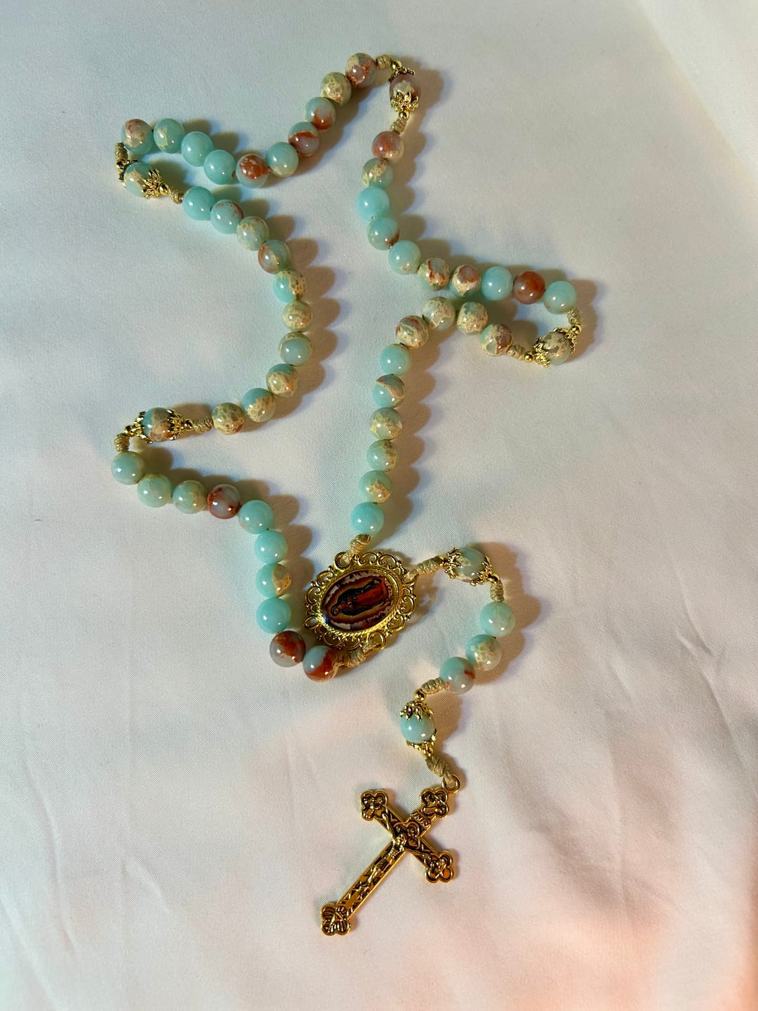 Customer photo review of Christianartworkshop Aqua Stone Prayer Rosary with Gold Accents: A Divine Source of Peace and Devotion