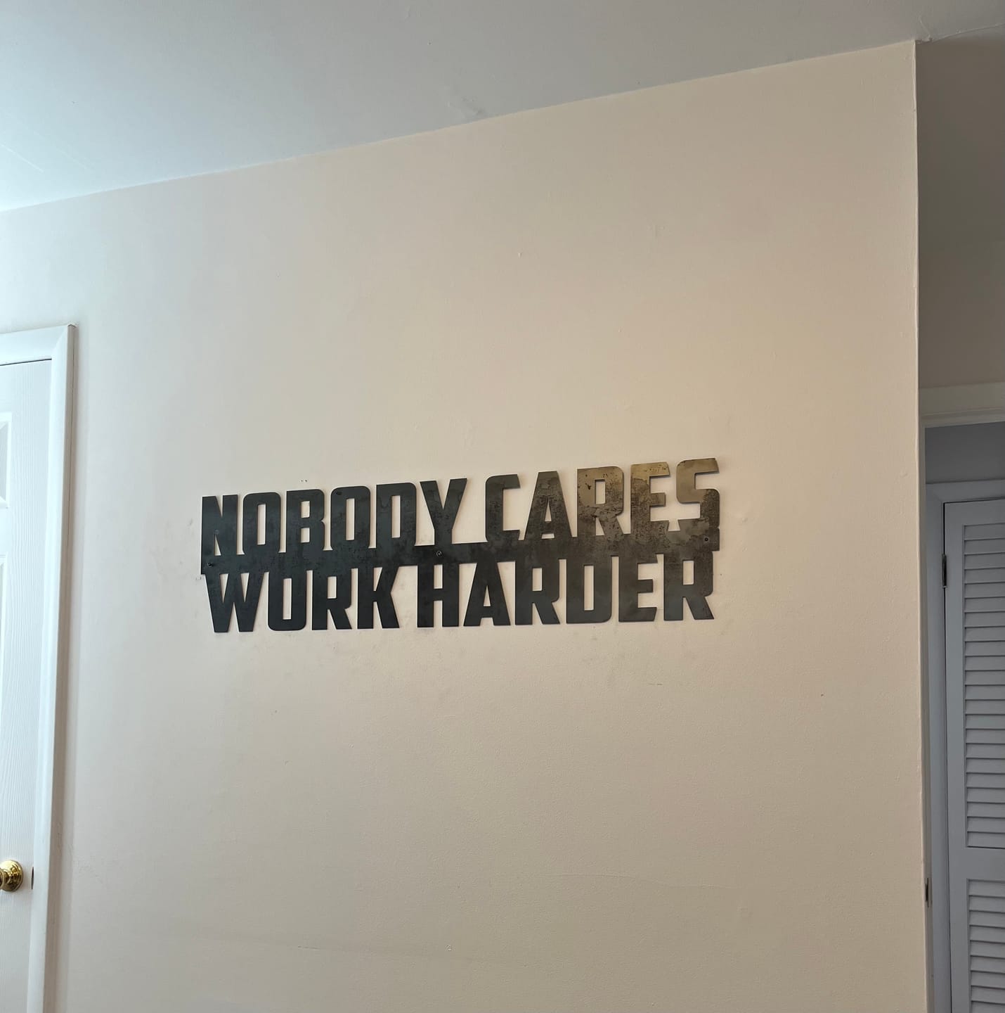 Customer photo review of Nobody Cares Work Harder - Metal Motivational Quote Sign