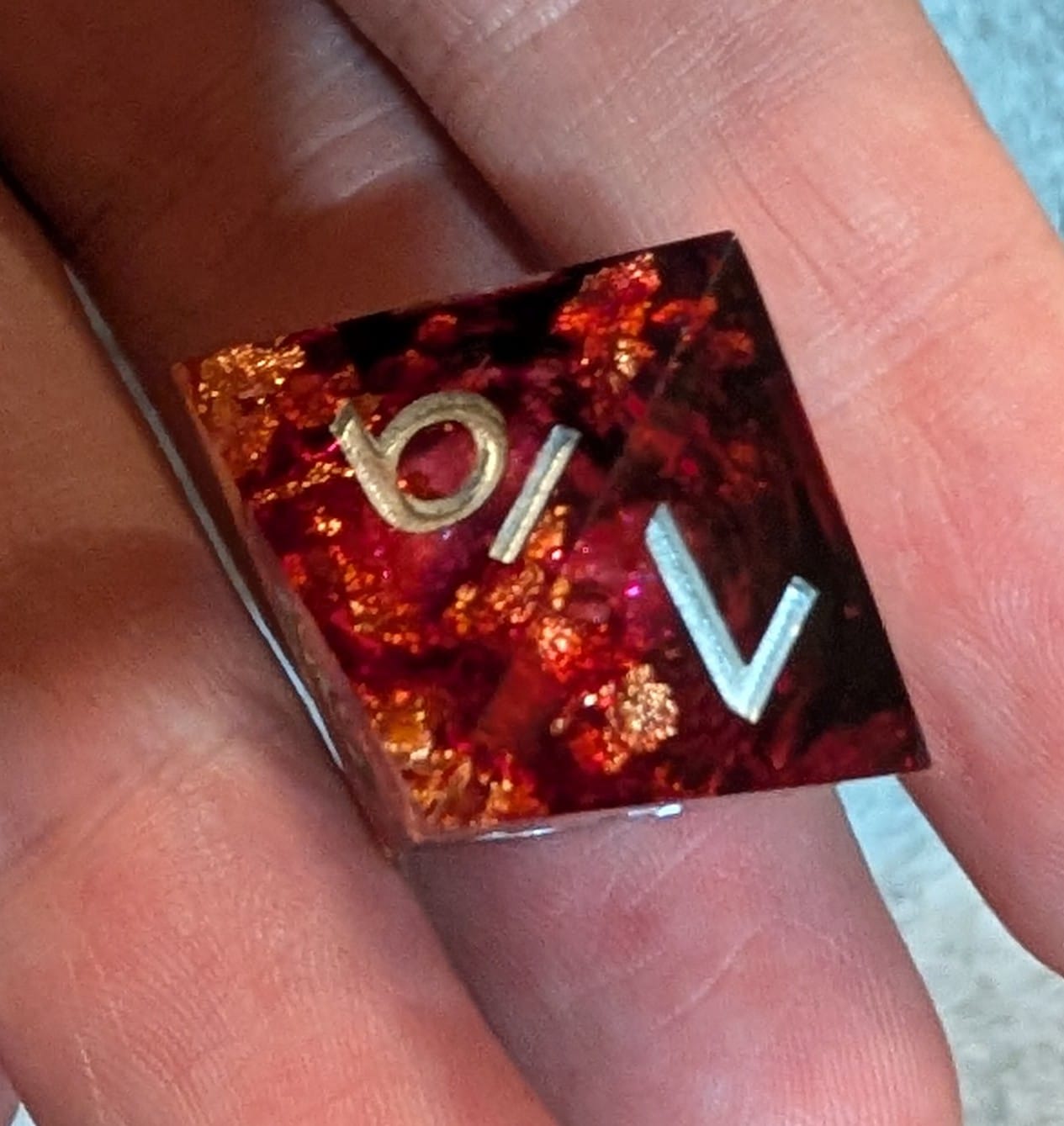 Customer photo review of URWizards D&D Bloody Liquid Heart Resin Engraved Dice Set Copper Flakes