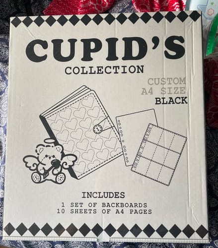 Packaging for the reviewer's black Cupid's Collection A4 binder, showing illustrations of the product.