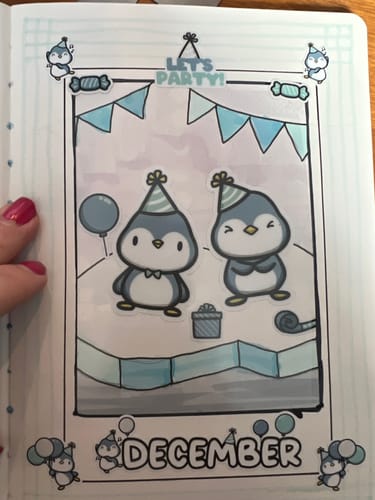 Reviewer's journal page for December, decorated with 'Party Penguins' stickers from the Journal Subscription.