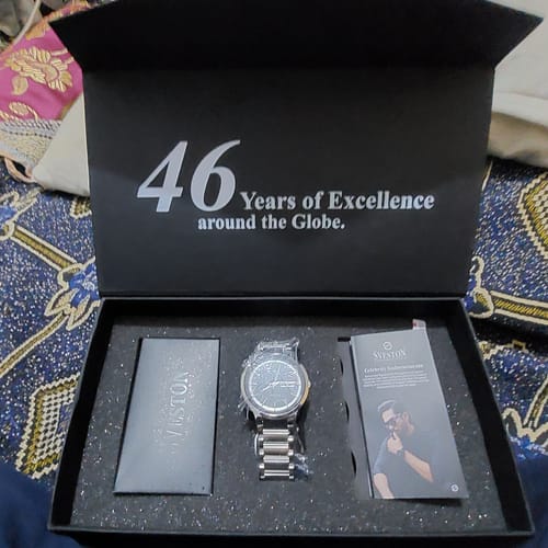 Customer's Aristos stainless steel watch displayed inside its open black presentation box.