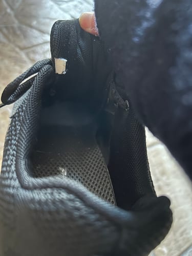 レビュー投稿者が、靴の消臭パウダーを使用した後の黒い靴の中を見せています。