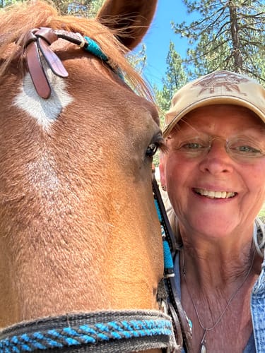 Reviewer smiling in a selfie with her horse after they both found relief using Joint X One.