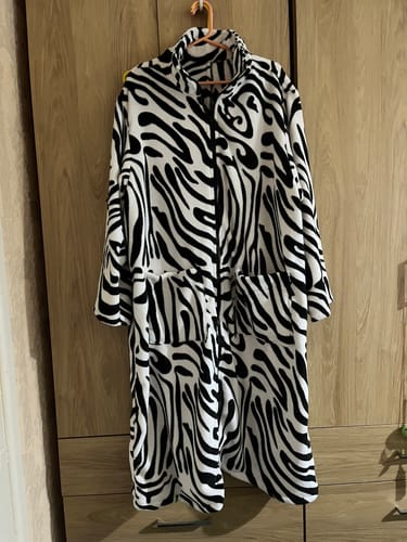 Customer's handmade robe made from the soft Zebra Waves Cuddle Fleece Fabric, hanging on a hanger.