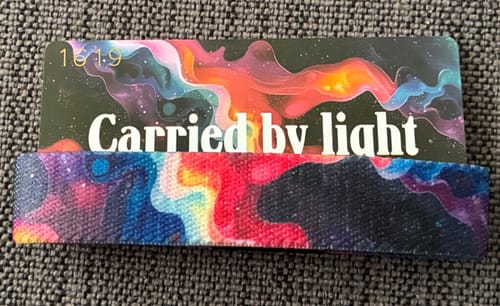 Customer's Carried By Light Bracelet shown with its colorful matching collector's card.