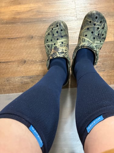 Customer wearing navy blue Performance Eucalyptus Compression Socks, pulled up to just below the knee.