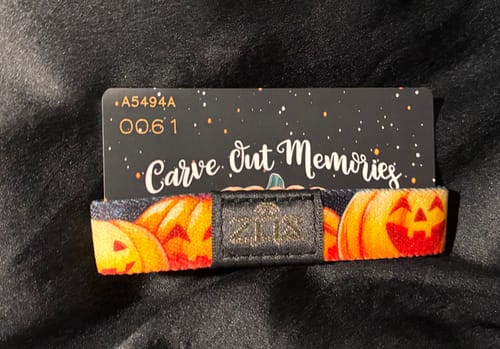 Customer's Carve Out Memories Bracelet with a jack-o'-lantern pattern, displayed with its themed backing card.