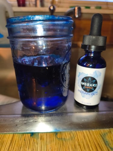Customer's Meraki Blu Methylene Blue bottle next to a glass jar filled with dark blue liquid.