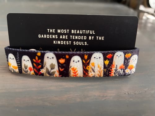 Reviewer's Kind Souls Bracelet featuring a cute ghost and flower pattern, shown on its packaging card.