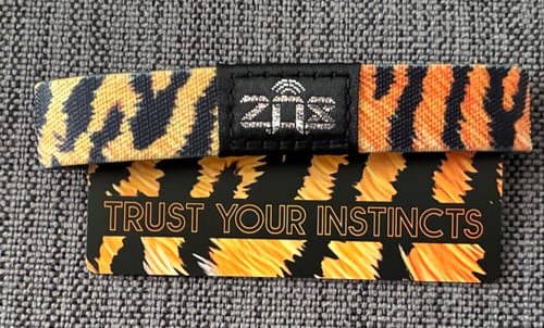 Customer's Trust Your Instincts Tiger Bracelet with a bold striped pattern laid flat with its matching card.