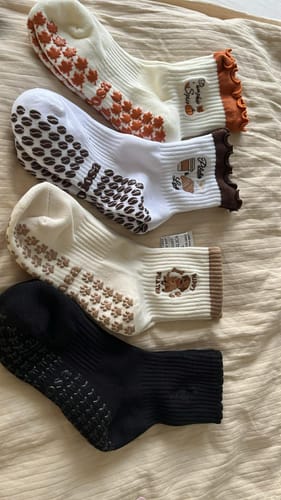 Customer's four different pairs of Puppy Pilates non-slip socks laid out on a flat surface.