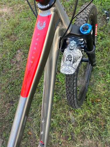 Customer's illustrated Maxwell Green Artist Series Fender mounted on their Banshee Phantom mountain bike.