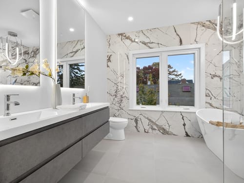 Customer's grey Monterey Floating Vanity with double sinks installed in a bright, modern bathroom.
