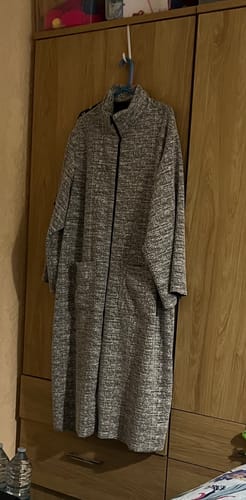 Customer's finished long robe made from the static print knit fabric, hanging on a wardrobe door.