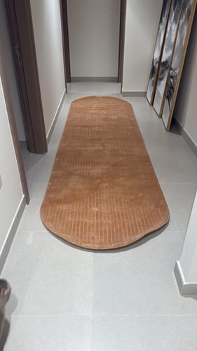 Customer's peach-colored handmade wool rug used as a long runner in a modern hallway.