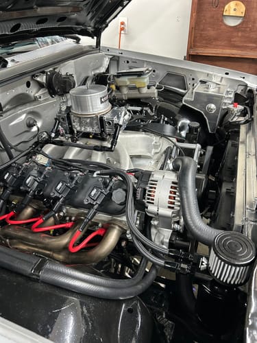 Reviewer's black Top Loader Billet Oil Catch Can installed in a clean engine bay.