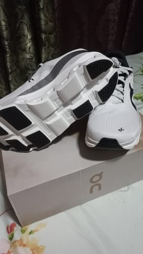 Customer's new white and black On Cloudmonster 2 shoes displayed on the shoebox, highlighting the cushioned sole.