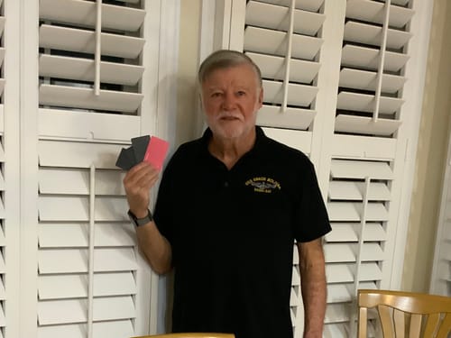 Customer holding the three black and one pink SPOTMINDERS Tracking Cards from his order.