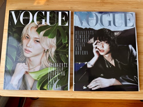 Reviewer's two copies of the Vogue Korea December 2025 issue featuring Stray Kids Felix, showing two different special covers.