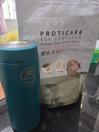 Customer's turquoise 316L Soup Flask on a countertop next to a Food Art soup mix packet.