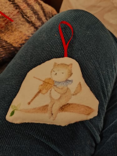 Customer's handmade Christmas ornament made from the Childhood Charms fabric, featuring a cat character playing a violin.