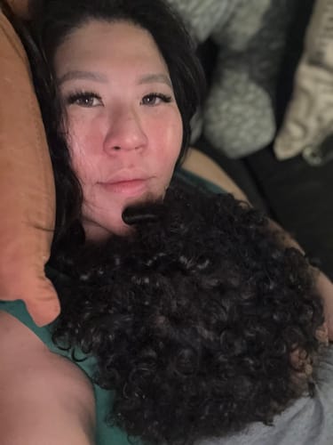 A reviewer's close-up photo showing off her long, fluffy Pro Curated Lash Bundles.