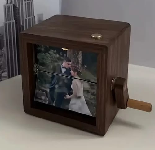 Customer's dark wooden Personalized Photo Box on a table, with a wedding photo displayed mid-turn.
