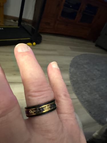 Close-up of a reviewer wearing the black Titanfall ring with its meteorite and gold flake inlay.