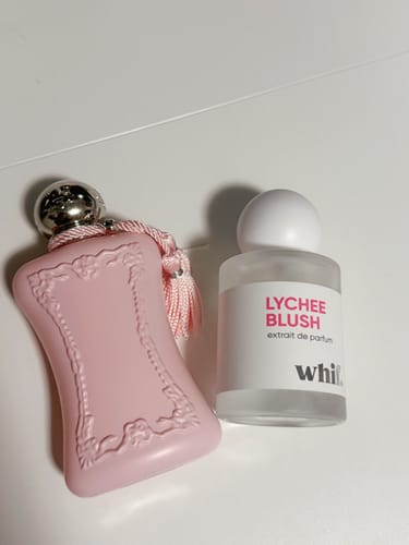 Customer's Lychee Blush perfume bottle shown next to the original pink Delina perfume bottle for comparison.