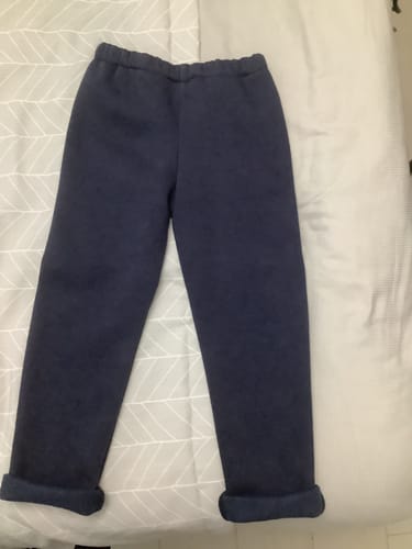 Customer's navy blue sweatpants made from the fabric, with the cuffs rolled up to show the soft fleece lining.