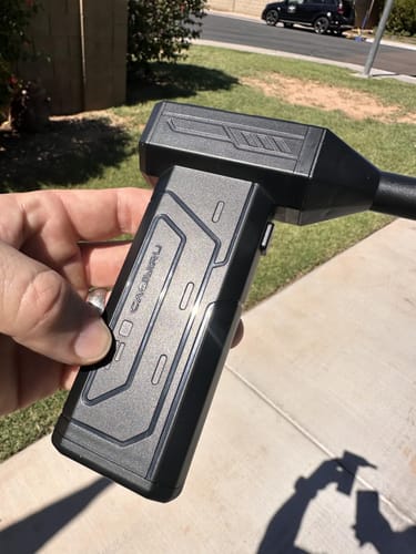 Reviewer holding the black, lightweight Litlamp™ Turbo LED Blower outdoors on a sunny day.