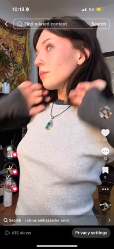 Reviewer wearing a teardrop crystal necklace from their VIP Crystal Club subscription.