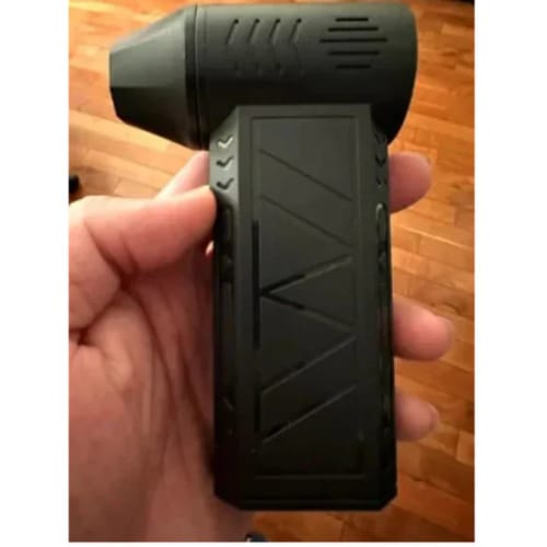 Reviewer holding the black Litlamp™ Turbo LED Blower in their hand, showing its compact size.