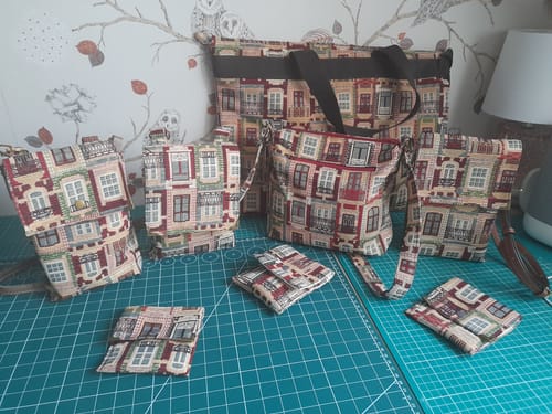 Customer displays various bags and purses handmade from the Lisbon Houses Tapestry Fabric.