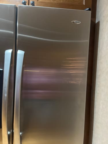 Customer's stainless steel refrigerator door with a shiny, streak-free finish after using the polish.