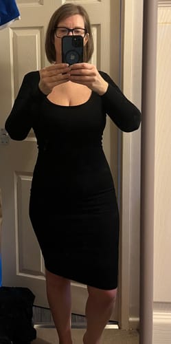Customer poses for a mirror selfie in the black Long Sleeve Midi Shapewear Dress.