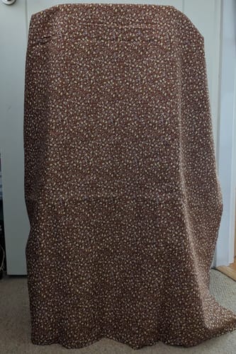 Customer's dark brown Mini Tulips Cotton Poplin Fabric with a floral print, draped over an object.
