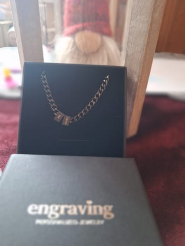 Customer's Legacy necklace with two personalized beads displayed in its black jewelry box.