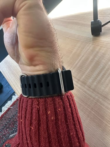 Customer demonstrates the black WatchBand Aquatic on their wrist, where the strap end is coming loose from the keeper loop.
