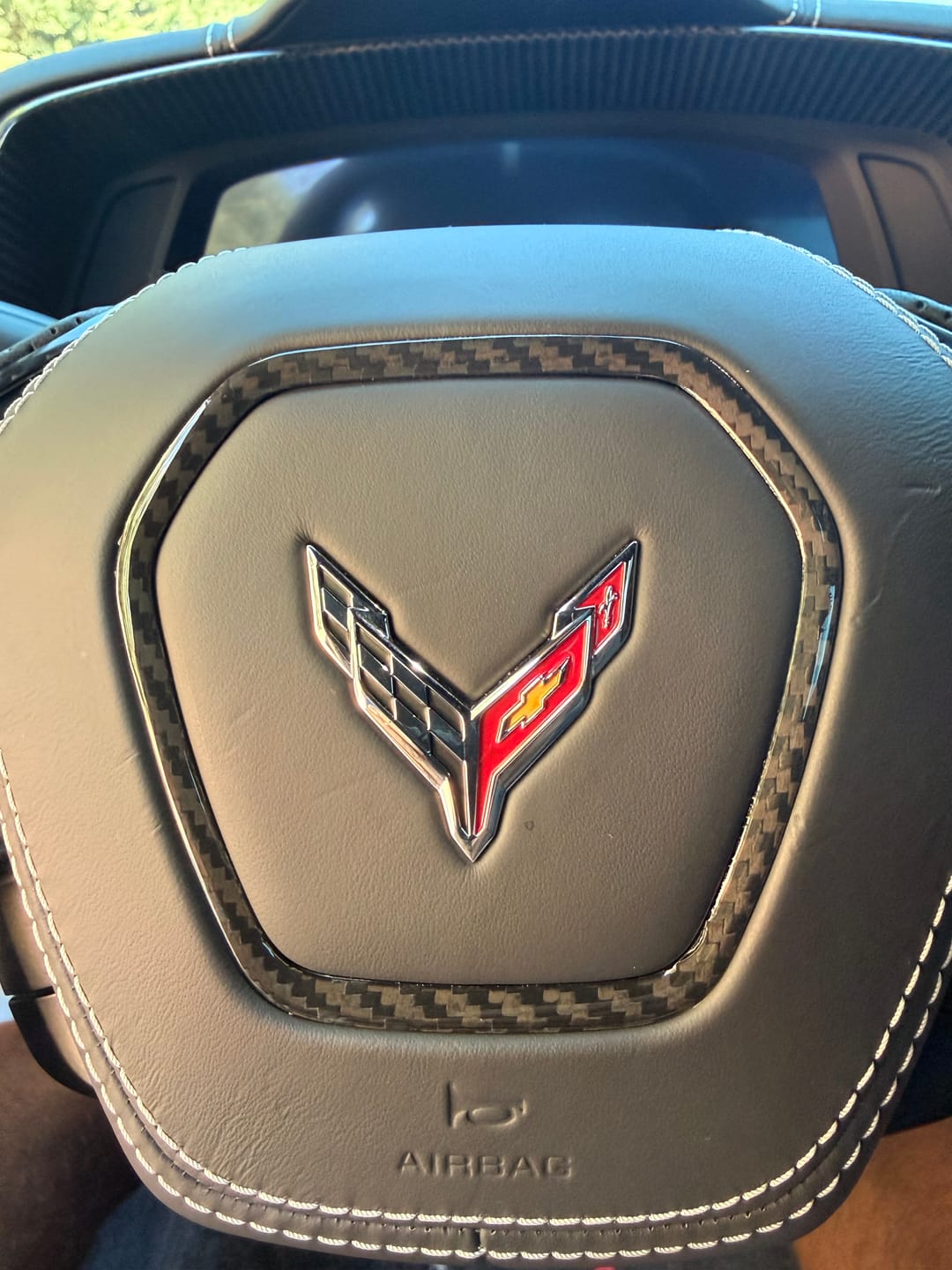 Customer photo review of C8 2020+ Corvette Carbon Fiber Steering Wheel Airbag Chrome Trim Delete Cover
