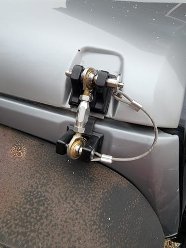 Customer's installed Hood Catch Kit with visible rust on the metal components.